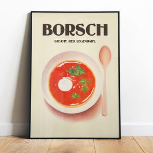 Peut inclure: Une affiche vintage avec le mot "BORSCH" en lettres brunes grasses. L'affiche présente un bol de soupe rouge au bortsch avec une cuillerée de crème sure et une garniture de persil. Le texte "STEAMY. RED. LEGENDARY." est sous le mot "BORSCH". Une cuillère en bois est à droite du bol.