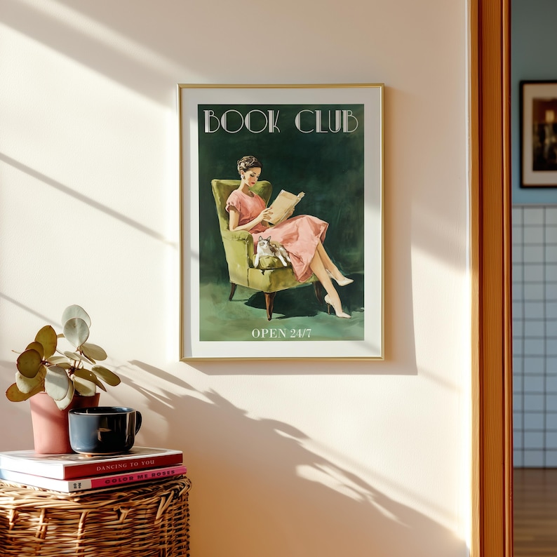 Vintage-style poster of a woman reading in an armchair with a cat, designed as book club art for a reading corner art space with a soft midcentury print feel, text reads “BOOK CLUB” and “OPEN 24/7”.