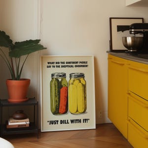 Retro-style digital art print of a green pickle jar with "Just Dill With It" text on a red background, styled as nostalgic kitchen wall decor.