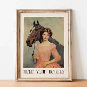 Retro-style digital art of a vintage girl in a pink dress standing beside a horse with the phrase "Hold Your Horses" beneath, ideal for funny horse decor or equestrian wall art.