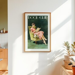 Vintage-style poster of a woman reading in an armchair with a cat, designed as book club art for a reading corner art space with a soft midcentury print feel, text reads “BOOK CLUB” and “OPEN 24/7”.