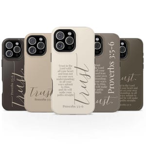 May include: A collection of five phone cases in various neutral tones, each featuring the word "Trust" in elegant script. The cases display the Bible verse Proverbs 3:5-6. The cases are designed to fit a smartphone.