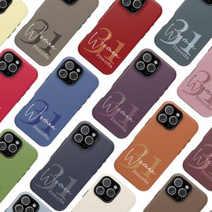 May include: A collection of colorful phone cases in various shades, including red, blue, and green. Each case features the text "Woman 31 Proverbs" in a stylish script. The cases are designed to fit a smartphone.