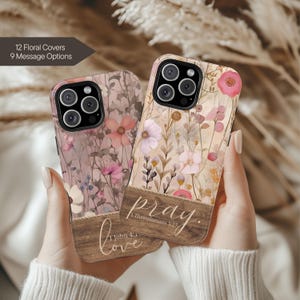 May include: Two floral phone cases with a wooden panel design. One case has the word "love" and the text "1 John 4:1" printed on it. The other case has the word "pray" and the text "1 Thessalonians 5:17" printed on it. The cases have a floral pattern.