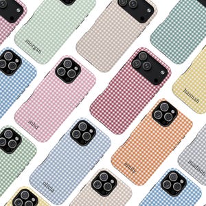 May include: A collection of smartphone cases featuring a repeating gingham check pattern in various pastel and vibrant colors. Each case includes a black camera module cutout and some feature personalized names printed in a small serif font.