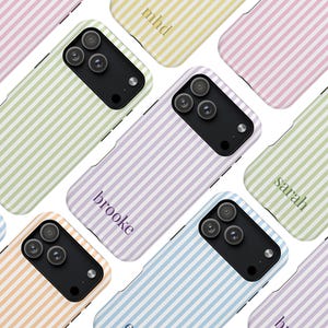 May include: A collection of colorful phone cases with vertical striped patterns in pastel shades of pink, yellow, green, blue, and orange. Each case features a black camera module and a personalized name in a matching color.