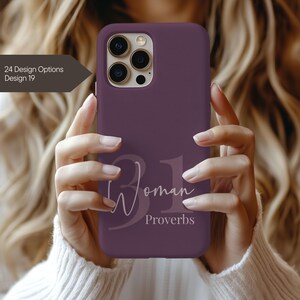 May include: A plum-colored phone case with the text "31 Woman Proverbs" in a white script font. The case has a matte finish and is designed for a smartphone. The image also includes the text "24 Design Options Design 19".