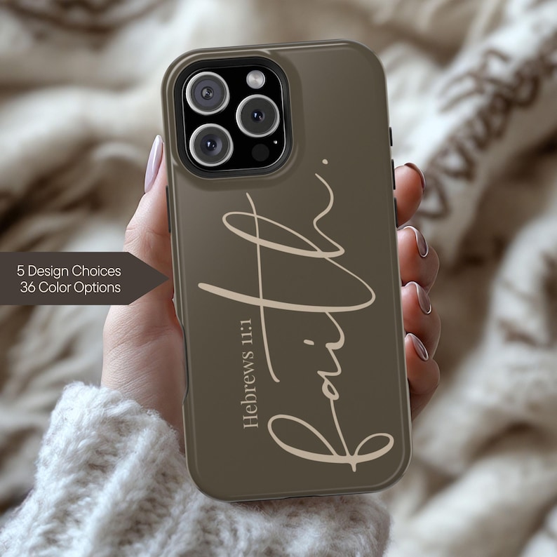 May include: Olive green phone case with the word "Faith" in a cursive font. The text "Hebrews 11:1" is below the word "Faith". The case has a camera cutout and a dark border. The image also shows text that says "5 Design Choices 36 Color Options".