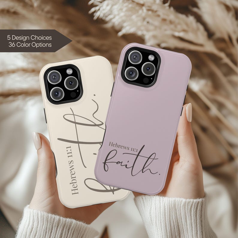 May include: Two phone cases, one cream and one lavender, are held up. The cream case has the text "Hebrews 11:1" and a script design. The lavender case says "Hebrews 11:1 faith." The image also shows "5 Design Choices 36 Color Options."