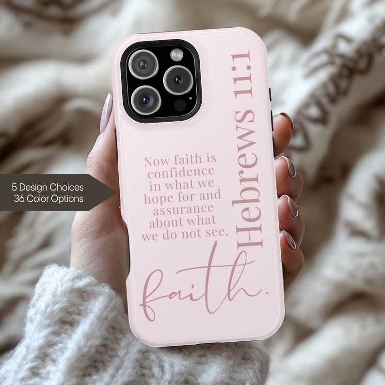 May include: A light pink phone case with the text "Hebrews 11:1" and the word "faith" in a script font. The case also features the quote "Now faith is confidence in what we hope for and assurance about what we do not see."