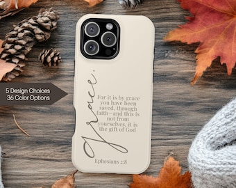 May include: A cream-colored phone case with the word "Grace" in cursive script. The case features text from Ephesians 2:8. The image also displays text indicating 5 design choices and 36 color options.