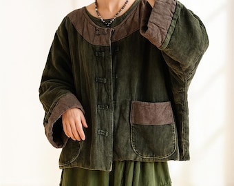 May include: A dark green jacket with brown accents. The jacket features a round neckline, a button-up front, and two front pockets. The sleeves and collar have a contrasting brown trim. The jacket is made of a textured fabric and has a relaxed fit.