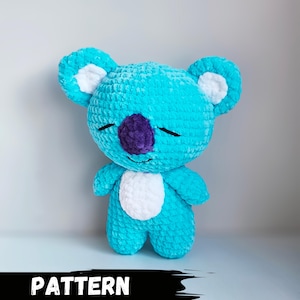 May include: A handmade turquoise plush koala bear with white accents on the ears and chest, and a purple nose. The koala has closed eyes and a smiling expression. The word "PATTERN" is displayed in bold, white letters at the bottom.