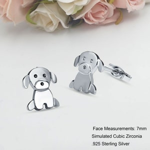 May include: A pair of silver dog-shaped stud earrings with clear cubic zirconia accents. Face Measurements: 7mm. Simulated Cubic Zirconia. .925 Sterling Silver.