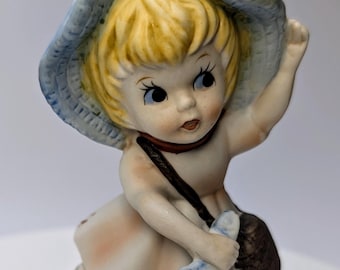Vintage - figurine - girl / blonde girl, pink dress, blue hat and fish in hand - porcelain - 5'' tall