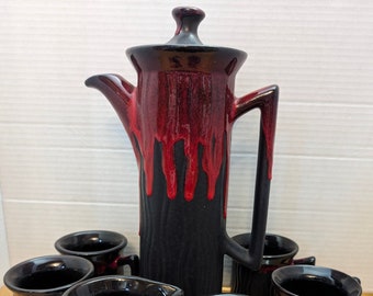 Vintage coffee and tea set by Beauce Pottery, featuring a striking 13''tall black and red lava drip design. Includes 8 pieces