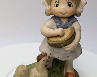 Vintage - figurine - girl/little girl feeding a chicken - porcelain - 5.5'' tall