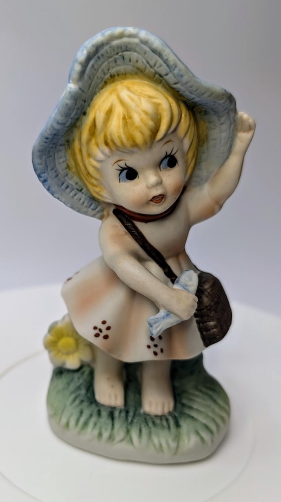 Vintage - figurine - girl / blonde girl, pink dress, blue hat and fish in hand - porcelain - 5'' tall