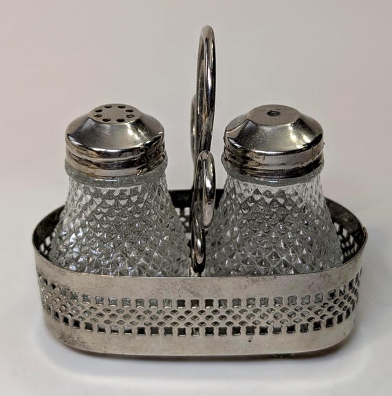 Vintage - Salt & Pepper Shakers with Metal Stand - measuring 3.5'' long x 2.5'' high