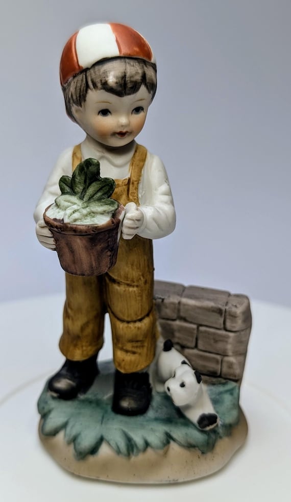 Vintage - figurine - Boy with cap with plant and dog - porcelain - 5'' tall