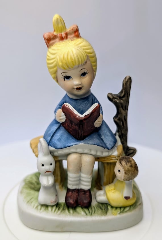 Vintage - Figurine - Girl / Blonde Girl, Blue Dress, Book, Bunny and Doll - Porcelain - 4''Tall