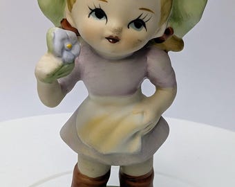 Vintage - figurine - Girl / girl in lilac dress, green hat and white flower - porcelain - 4.5'' tall