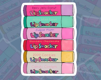 May include: A stack of six Lip Smacker flavored lip balms. The flavors are Berry Jelly Donut, Nilla Mint Frost, Sugar Plum, Strawberry Cheesecake, 2000 Cookies, and Candy Confetti.