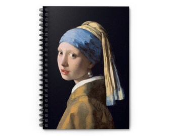 May include: Spiral-bound notebook featuring a print of Johannes Vermeer's "Girl with a Pearl Earring." The artwork depicts a young woman with a blue headscarf and a pearl earring, set against a dark background. The notebook has a white cover and a black spiral binding.