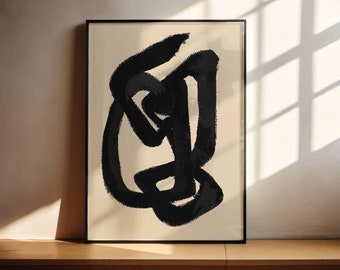 May include: Black and white abstract art print in a black frame. The print features a large, bold, black abstract shape on a cream background.