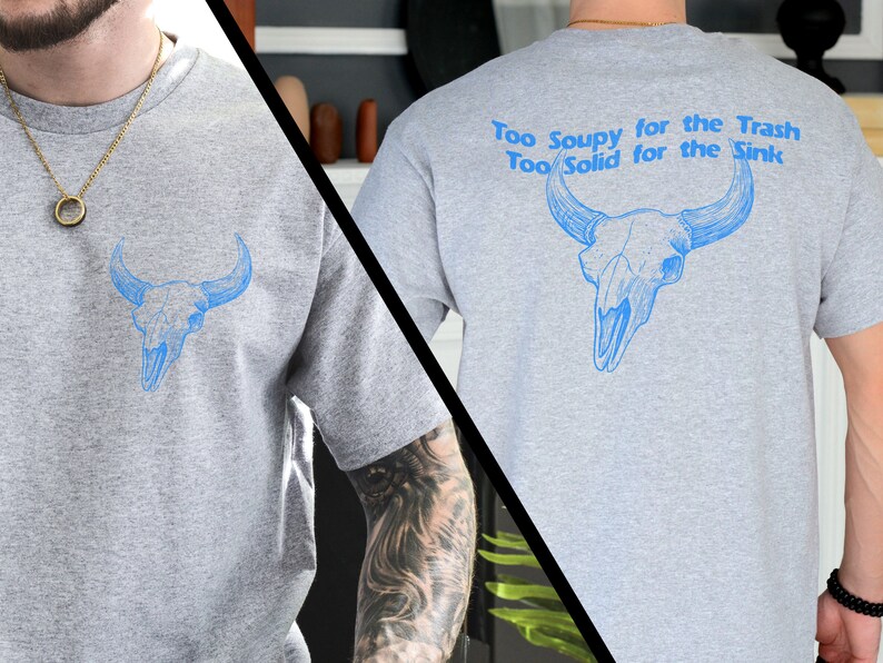 May include: Gray t-shirt with a blue bull skull graphic on the front and the text "Too Soupy for the Trash Too Solid for the Sink" on the back.
