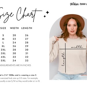 May include: Size chart for a Gildan 18000 crewneck sweatshirt, showing width and length measurements in inches for sizes S through 5XL. The chart shows that a size S is 20 inches wide and 26 inches long, a size M is 22 inches wide and 27 inches long, a size L is 24 inches wide and 28 inches long, a size XL is 26 inches wide and 29 inches long, a size 2XL is 28 inches wide and 30 inches long, a size 3XL is 30 inches wide and 31 inches long, a size 4XL is 32 inches wide and 32 inches long, and a size 5XL is 34 inches wide and 33 inches long. The chart also includes a photo of a model wearing a size S sweatshirt.