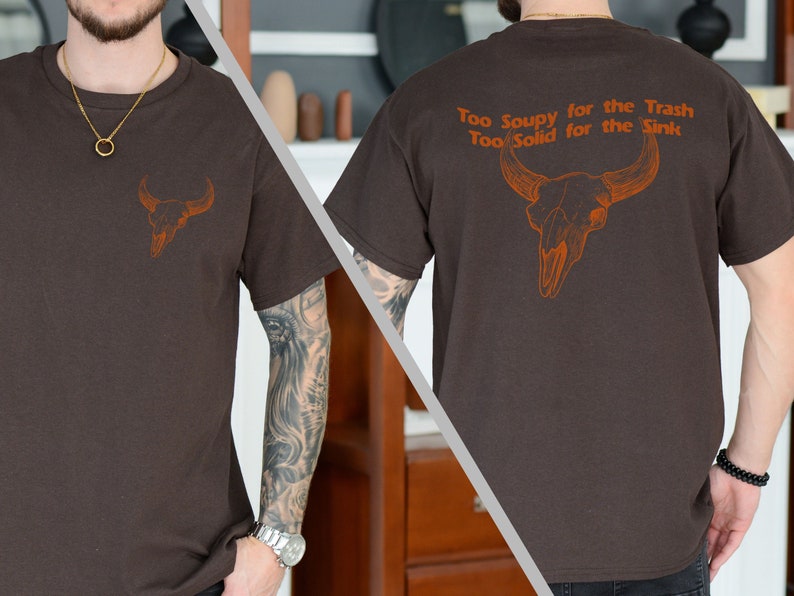 May include: A brown t-shirt with a skull and crossbones graphic on the front and the text "Too Soupy for the Trash Too Solid for the Sink" on the back.