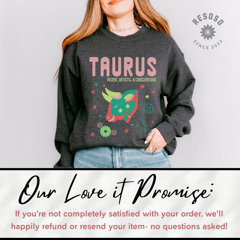 May include: A dark gray sweatshirt with the word "TAURUS" in pink lettering and a green and red bull illustration. The text "PATIENT, ARTISTIC, & CONSCIENTIOUS" is below the word "TAURUS".