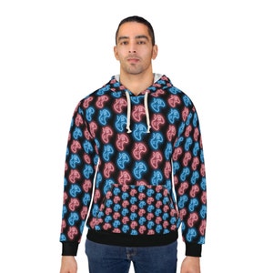 Pode incluir: Um moletom preto com um padrão de gamepad azul e rosa neon. O moletom tem um capuz com cordão e um bolso canguru.