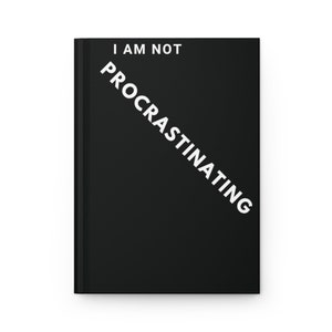 May include: A black notebook with the text "I am not procrastinating" written diagonally in white.