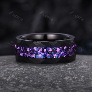 May include: A black tungsten carbide ring with a hammered finish and a purple and blue glitter inlay.