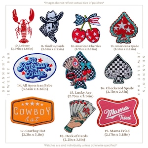 May include: A collection of embroidered patches featuring various designs including a red lobster, a skull with playing cards, cherries with a flag bow, a spade, text reading All American Babe, a lucky ace, a checkered spade, a cowboy hat, cards, and Mama Fried.