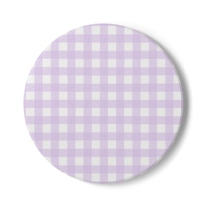 May include: A round coaster with a light purple and white gingham pattern. The coaster is made of a solid material and has a smooth surface. The design is a classic, simple pattern.
