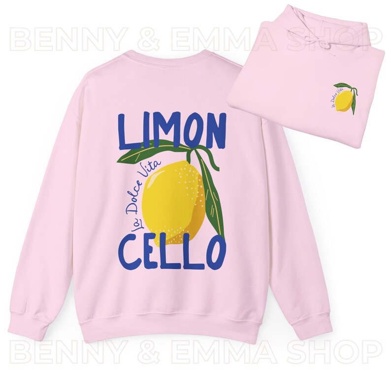 May include: Pink sweatshirt with a blue and yellow lemon graphic and the text "Limon La Dolce Vita Cello".