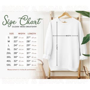 May include: Size chart for Gildan 18000 sweatshirt with measurements in inches and centimeters. The chart shows the width and length of the sweatshirt for sizes S through 5XL.