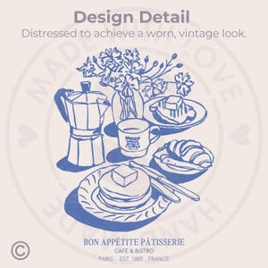 May include: A blue and white illustration of a breakfast scene with a coffee pot, a cup of coffee, a plate of croissants, a plate of pancakes with butter, and a vase of flowers. The text "BON APP&Eacute;TITE P&Acirc;TISSERIE CAF&Eacute; & BISTRO PARIS EST. 1889 FRANCE" is at the bottom of the image.