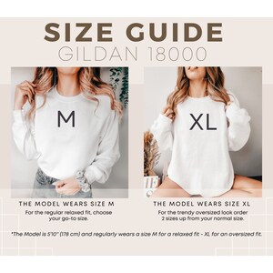 May include: Size guide for Gildan 18000 sweatshirts. The model is wearing a size M and a size XL. The model is 5'10" (178 cm) tall. The size M is a relaxed fit and the size XL is an oversized fit.