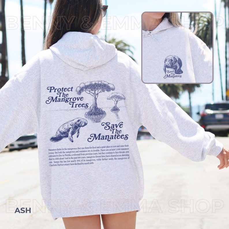 May include: A gray hooded sweatshirt with a blue graphic print on the back. The graphic features a manatee swimming near mangrove trees and the text "Protect The Mangrove Trees" and "Save The Manatees".