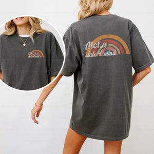 May include: A dark gray oversized t-shirt with a rainbow graphic and the text "Aloha state of mind" printed on the back.