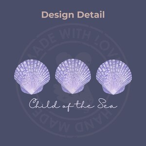 Pu&ograve; includere: Tre conchiglie viola con un motivo a strisce bianche e viola. Le conchiglie sono disposte in fila e sono centrate su uno sfondo blu scuro. Il testo "Child of the Sea" &egrave; scritto in corsivo bianco sotto le conchiglie. Un timbro circolare con il testo "Made with Love Hand Made" &egrave; dietro le conchiglie.