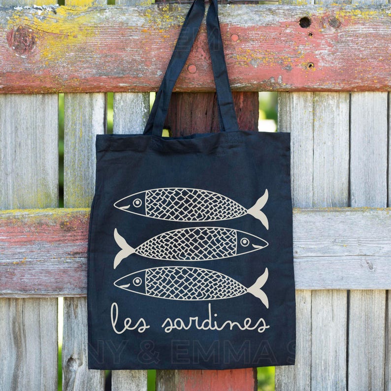 May include: Black tote bag with a white design of three sardines and the text "les sardines NY & EMMA".