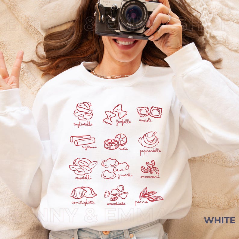 May include: White sweatshirt with a red graphic of different types of pasta with their Italian names.