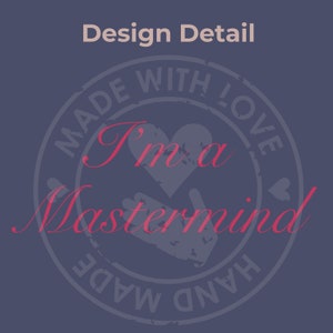 May include: A blue and white circular stamp with the text "Made with Love, Hand Made" and the words "I'm a Mastermind" in red. The stamp has a heart and two hands in the center.