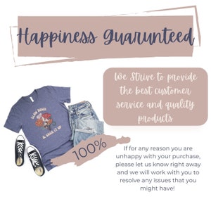 May include: A blue t-shirt with the text "Slow Down & Soak It Up" and a floral design. The t-shirt is paired with blue jeans and black trainers. The image also includes text that says "Happiness Guaranteed" and "We strive to provide the best customer service and quality products".