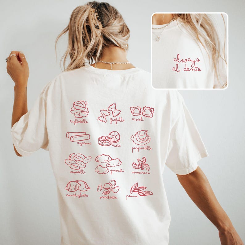 May include: White t-shirt with a red graphic of different types of pasta with their Italian names. The text "always al dente" is on the back of the shirt.